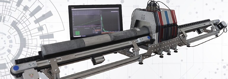 Fig. 1 Full length image of the gamma ray core sampler comprised of the measurement section with 3 detectors and the conveyor system including a rock core sample which is being analysed (Image courteously provided by Georadis)